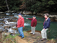 Men looking at creek